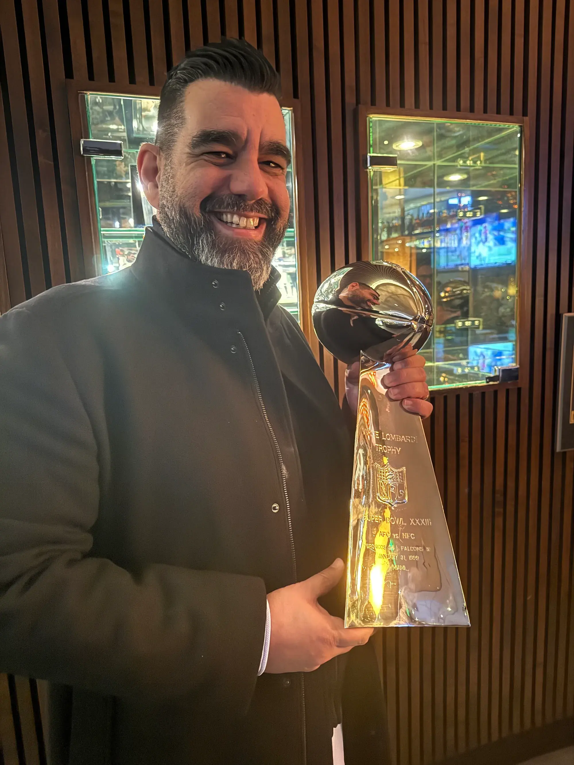 Marios Fakiolas holding the Vince Lombardi Super Bowl trophy